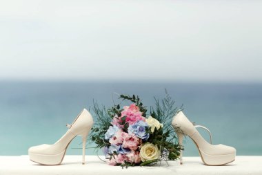 Beyaz düğün ayakkabıları ve beyaz zengin buket kürsüye wi masa