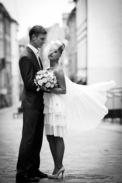 Fiance admires a beautiful bride in short dress 
