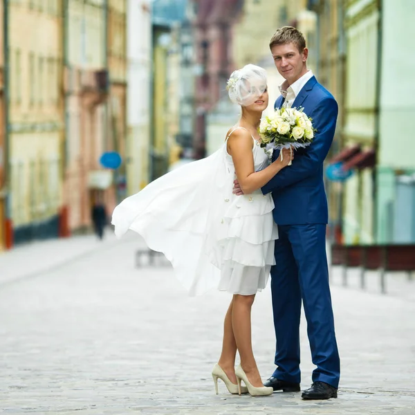 Gelinin kısa elbise Rüzgar darbeler uzakta iken o bir damat o eğilir