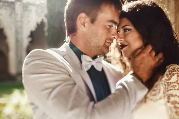 Красивий наречений виглядає в красивих очах нареченої, поки сонячний шлюп — стокове фото