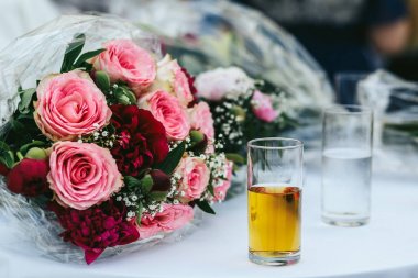 Elma suyu ile cam arkasında bir pembe düğün masada duruyor