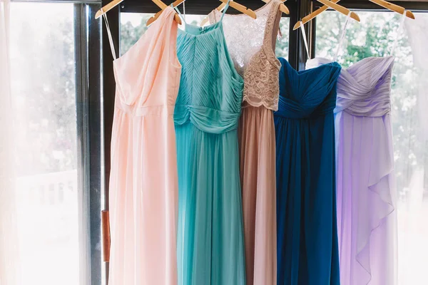 Pastel colorful dresses hang on the pegs — Stock Photo, Image