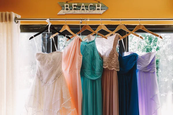 Flecha con letras 'Playa' cuelga sobre los vestidos de pastel —  Fotos de Stock