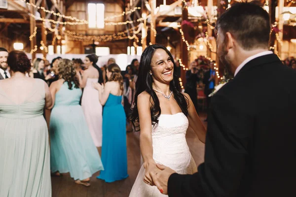 Невеста выглядит очаровательно, улыбаясь жениху во время их первого — стоковое фото