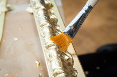 altın renkli tavan için bir fırça baget ile el boyama