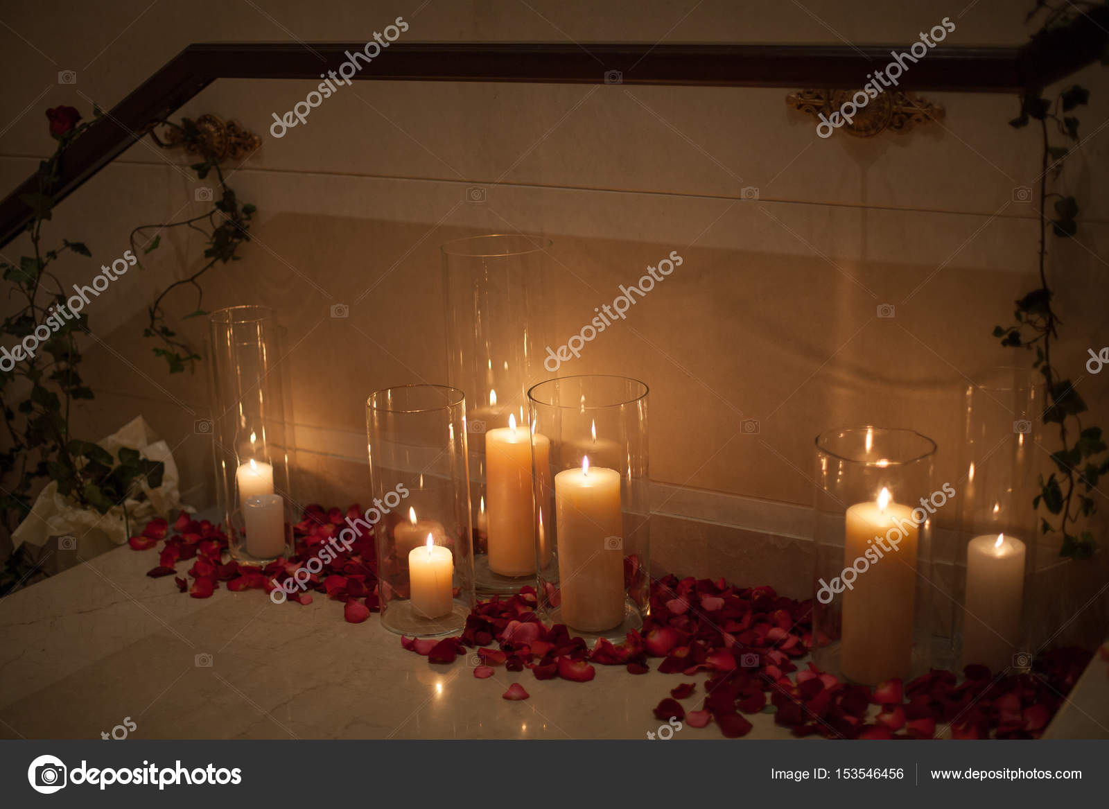 Candle Surrounded By Red Rose Petals With Dreamy Reflection
