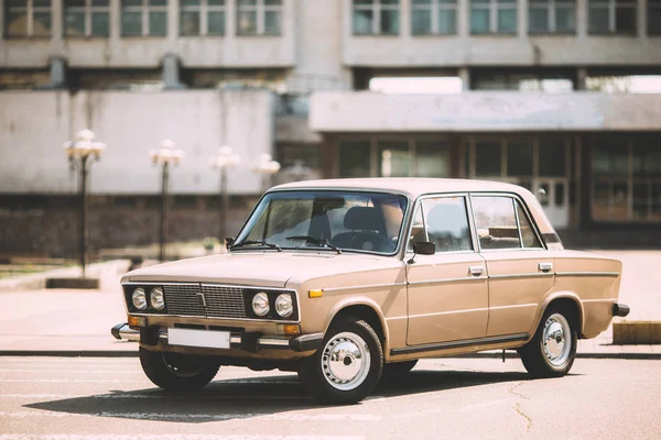 A retro car made in the USSR stands on the background of Kiev Polytechnic Institute. Kiev, Ukraine. — Stock Photo, Image