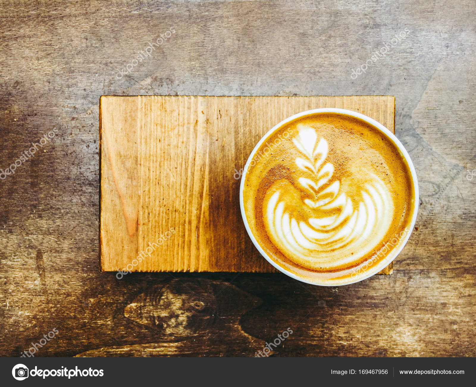 https://st3.depositphotos.com/4676639/16946/i/1600/depositphotos_169467956-stock-photo-cappuccino-cup-on-the-wooden.jpg