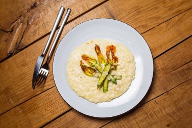 bir restoranda ahşap bir masa üzerinde sebzeli risotto