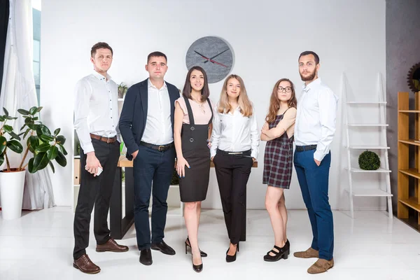 Smiling employees standing looking camera making team picture in office together. Business People Team. Successful company with happy workers. People Meeting Communication Corporate Teamwork Concept