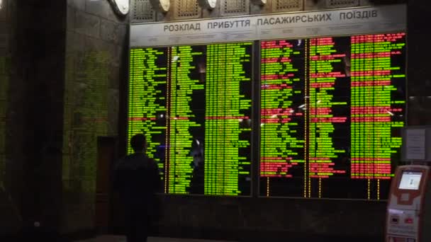 Kiev Ukraine March 8 2018 Train Schedule Central Railway Station In Kiev Passengers Looking At The Electronic Departures And Arrivals Board In The Main Train Station Of Kiev Stock Video C Veloliza 326470630