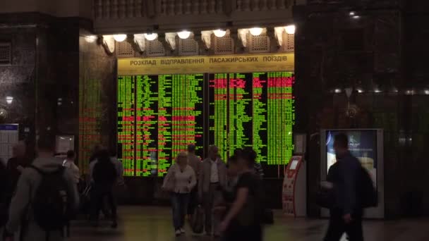 Kiev, Ukraine - March 8, 2018: Train schedule. Central Railway station in Kiev. Passengers looking at the electronic departures and arrivals board in the main train station of Kiev — Stock Video