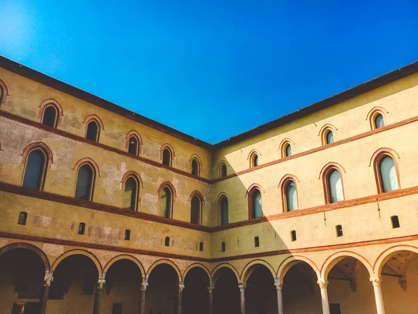 medieval Castle of Sforza or Castello Sforzesco and beautiful Sempione park in the heart of Milan, Lombardy, Italy. 15th century by Francesco Sforza, Duke of Milan