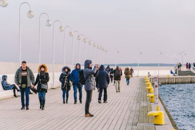 Sopot Pier Molo, 9 Şubat 2020 'de Polonya' nın Sopot şehrinde. Baltık Denizi 'nde bulunan Sopot' taki ünlü eski ahşap iskelede soğuk kış günü. İnsanlar Sopot 'ta Avrupa' nın en uzun tahta iskelesinde yürüyor..