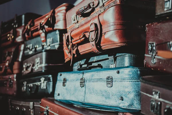 stack of old suitcases that have seen a lot of traveling. retro luggage. Lots of vintage leather suitcases.