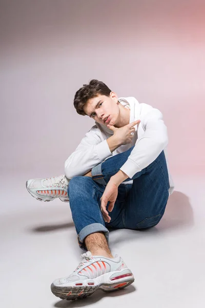 Pensive Teen Boy Posing Sitting Floor Studio Portrait Stylishly Dressed — Stock Photo, Image