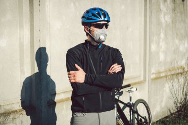 Şehirdeki duman yüzünden maskeli bir bisikletçi. Bisikletli kurye teslimat yapıyor. Covid 19 Coronavirus maskesi takan bir adam. Bushfire dumanından dolayı kirlilik maskesi takan bisikletçi. Kargo Servisi.