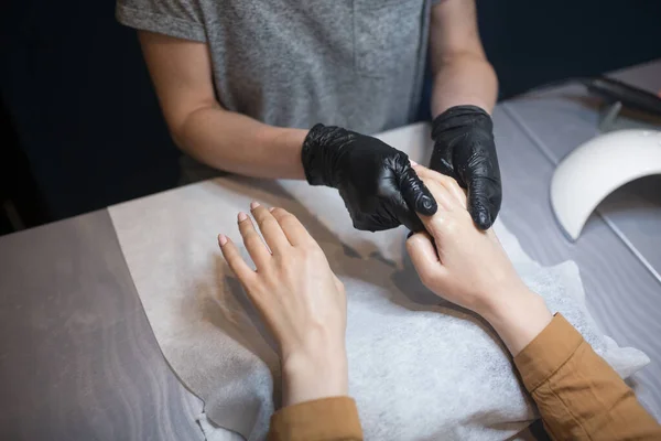 Beautician applying cream on client hands. Beauty salon. Hands Massage. Manicure at salon. Spa Manicure concept. Female hands with delicate manicure and moisturizing cream. Soft skin. Hand, beauty.