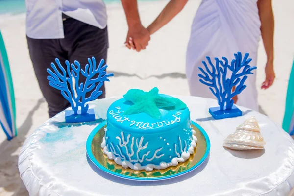 Tropical wedding cake for bride and groom to cut during destination wedding marriage outdoor ceremony on the sandy beach in Dominican republic