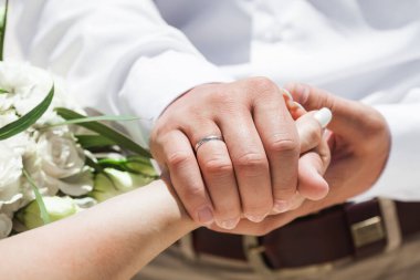 Gelin ve damat, Dominik Cumhuriyeti, Punta Cana 'da okyanusun kıyısındaki kumsalda deniz manzaralı düğün sırasında yüzüklerini değiş tokuş ediyorlar.  