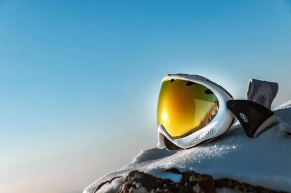 yellow ski goggles and snowboarder in the mountains