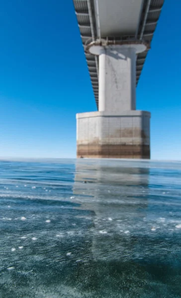 Support of an automobile bridge in a frozen river — Stock Image Support Automobile Bridge Frozen River Royalty Free Stock Images
