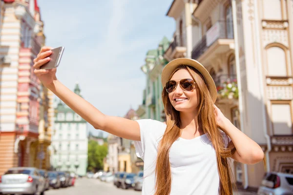 Atraktivní dívka v létě klobouk a brýle chůzi ve městě — Stock fotografie