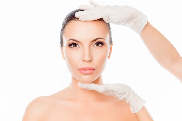 Doctor checking woman's skin before plastic surgery — Stock Photo, Image