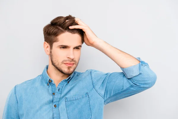 Portrait of handsome stylish young man touching his hair — Stock Photo, Image