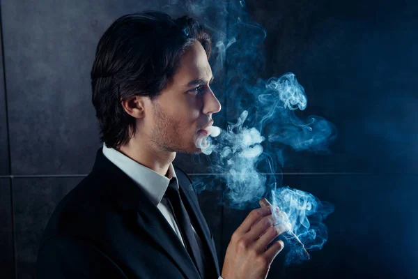 시가 흡연 하는 잔인 한 잘생긴 남자의 측면 보기 사진 — 스톡 사진