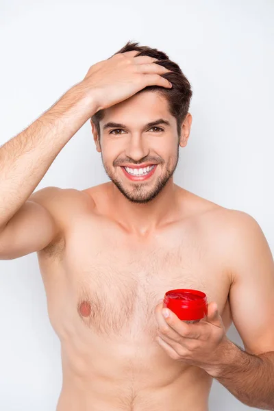 Portrait of young smiling man holding jar of gel for hair — Stock Photo, Image