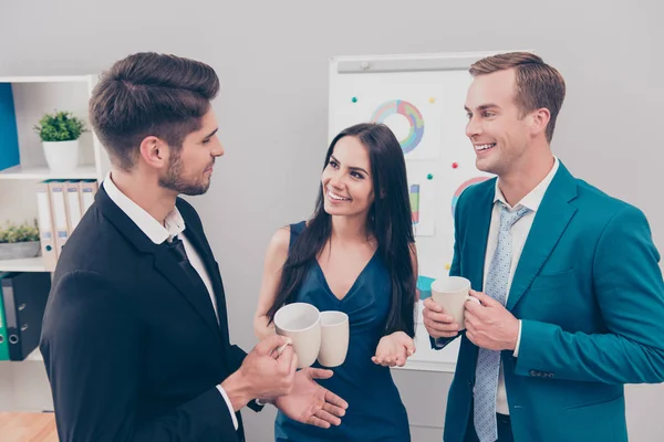 Happy colleagues having break and talking over a cup of coffee — Stock Photo, Image