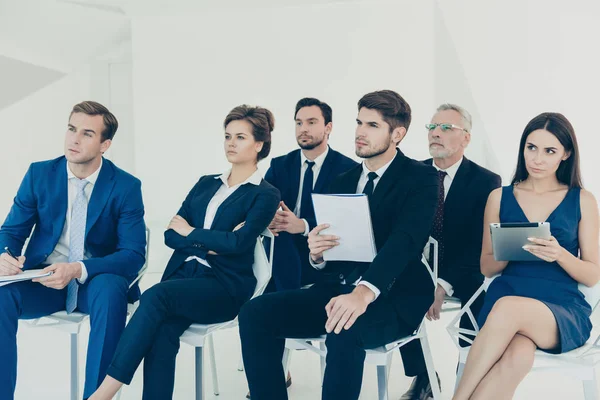 Confident young managers making notes during lecture — Stock Photo, Image