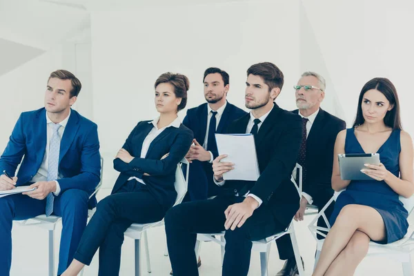 Jóvenes gerentes confiados haciendo notas durante la conferencia — Foto de Stock