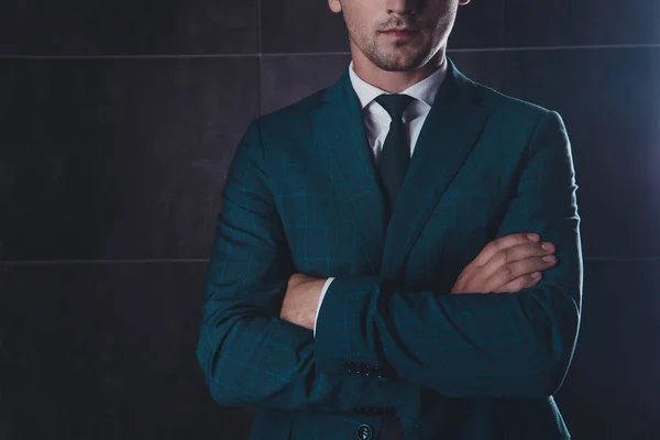 Close up of young businessman in black suit with crosed hands — Stock Photo, Image