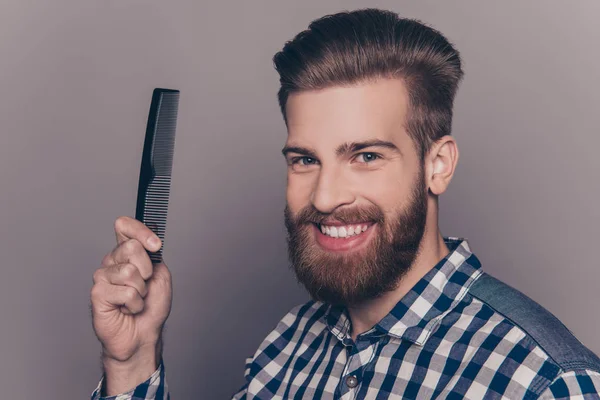Portrait of handsome cheerful bearded man showing comb — Stock Photo, Image