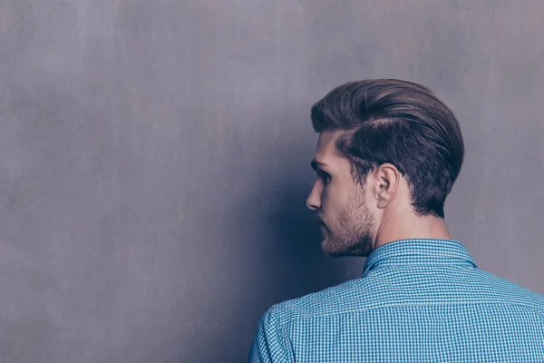 Back view of young modern brunet man on gray background — Stock Photo, Image