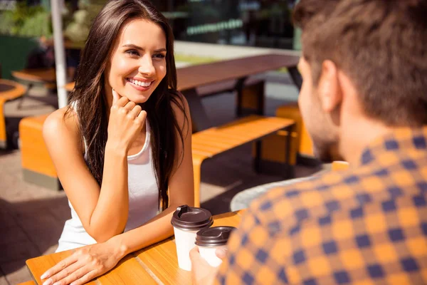 Smiling couple in love talking in outdoor cafe and drinking coff — Stock Photo, Image