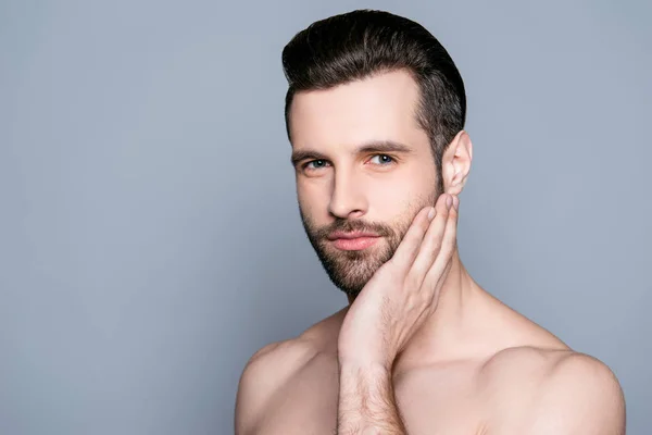 Handsome young man touching his face before shaving — Stock Photo, Image