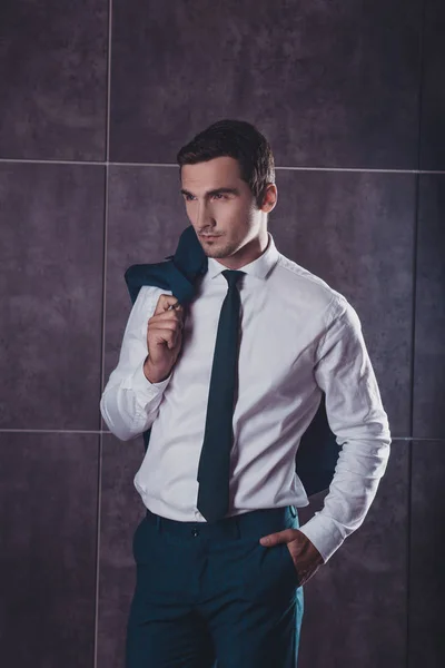 Portrait of young successful handsome businessman holding jacket — Stock Photo, Image