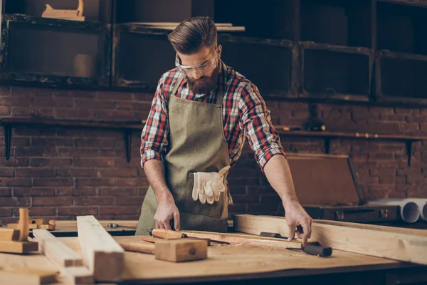 Young stylish craftsman with glasses and hairstyle holding measu — Stock Photo, Image