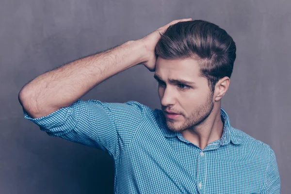 A portrait of young confident handsome man touching his hair — Stock Photo, Image