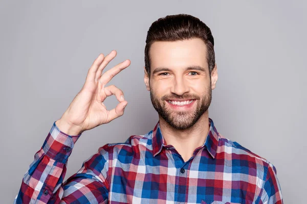 Een knappe in geruite hemd man geïsoleerd op grijze achtergrond sh — Stockfoto