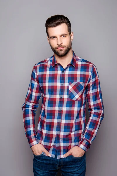 Vertical portrait of young stylisg guy in checkered shirt holdin — Stock Photo, Image