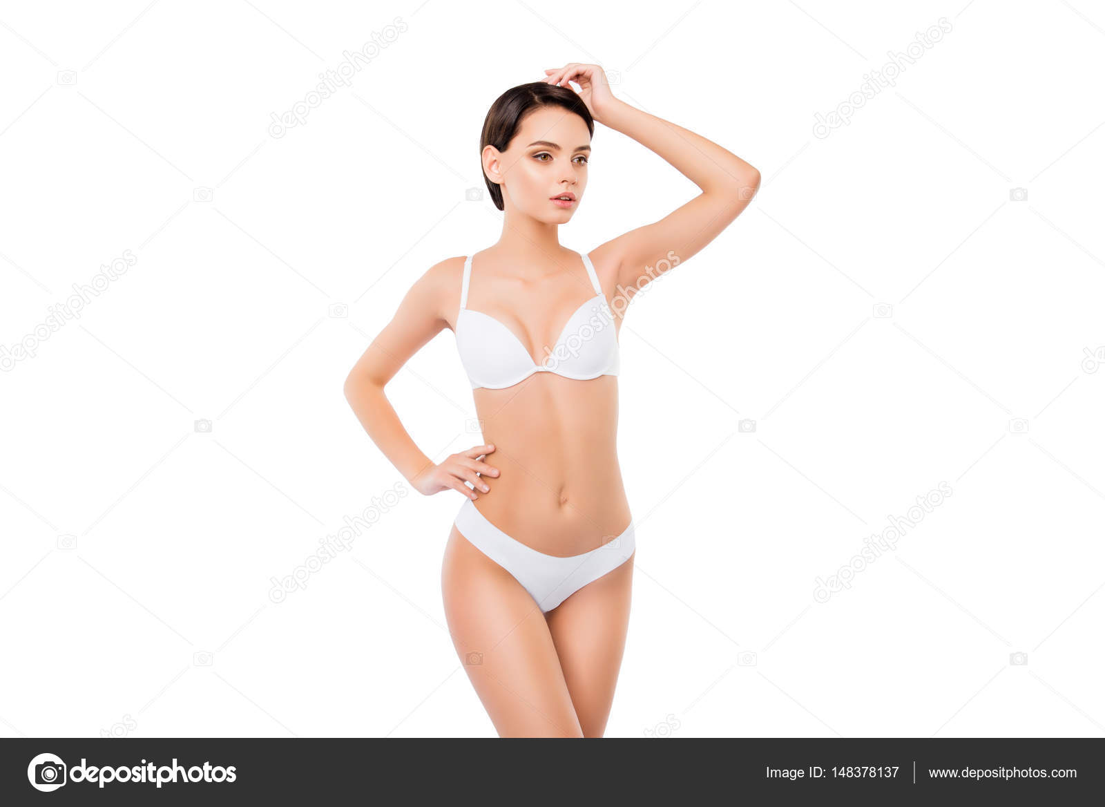 Foto de Young pretty woman on isilated background in white underwear.  Beautiful girl in perfectly clean underclothes do Stock