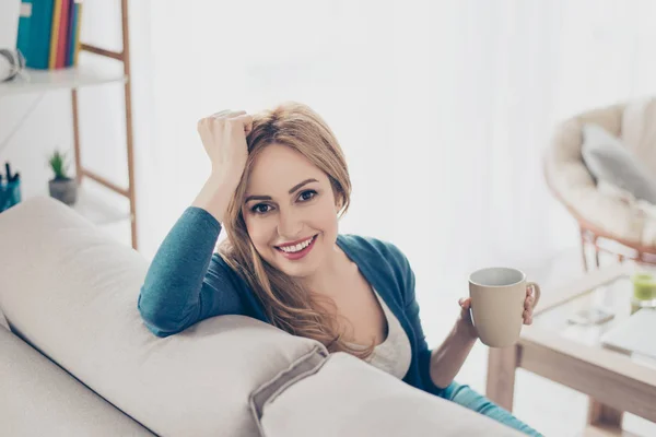 Молодая довольно милая женщина наслаждается кофе по утрам сидя о — стоковое фото