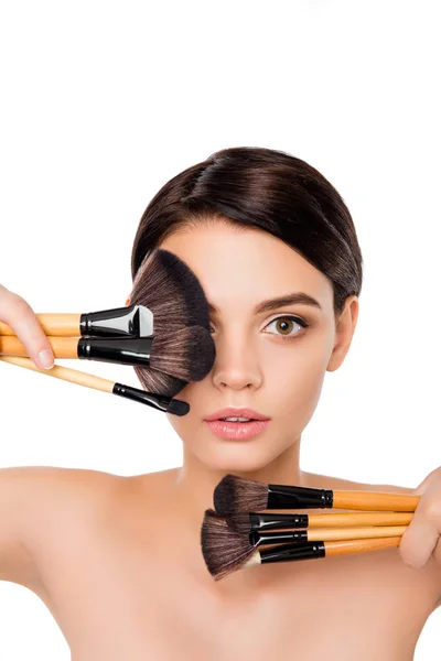 Portrait of young beautiful woman holding makeup brushes Royalty Free Stock Images