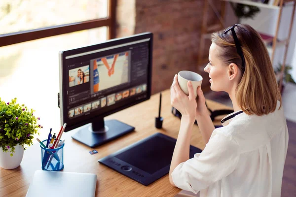 Female graphic designer sitting near screen and graphic tablet a — Stock Photo, Image