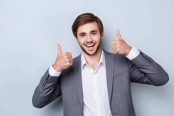 Excited successful handsome young man in formal wear showing ges — Stock Photo, Image