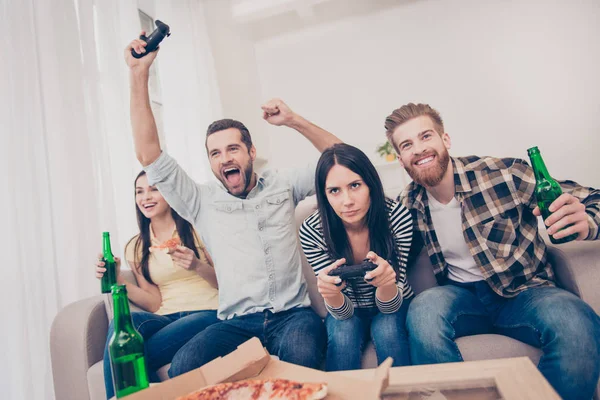 Jóvenes celebrando fiesta en casa con videojuegos, pizza y cerveza . — Foto de Stock